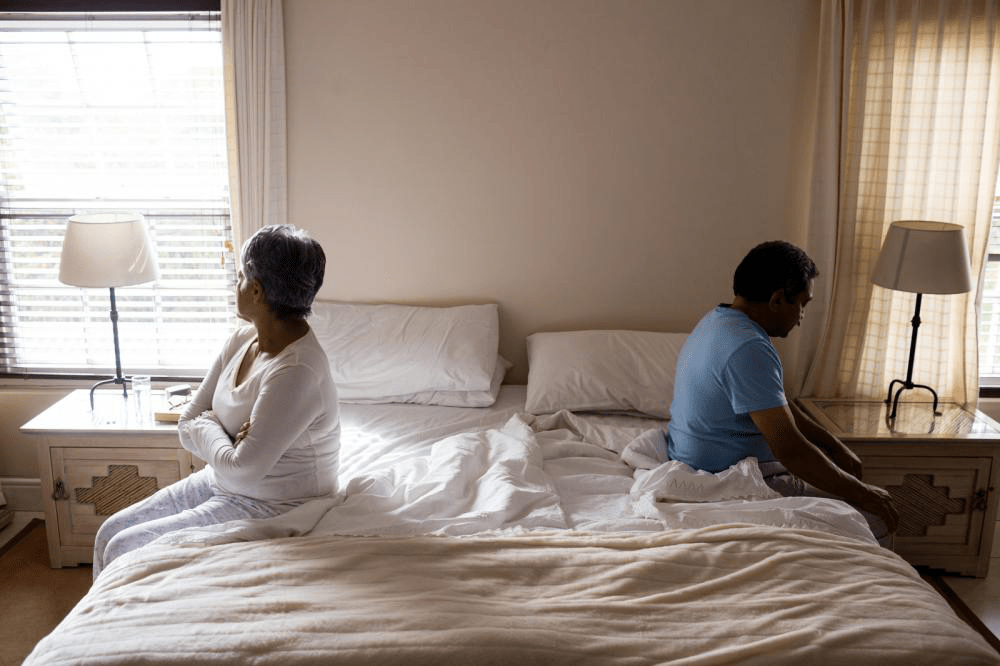 couple sitting with their backs to each other because of a misunderstanding