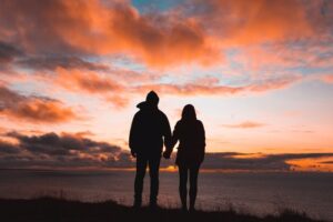 A silhouette of a couple holding hands