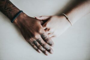 Cross-cultural couple holding hands.