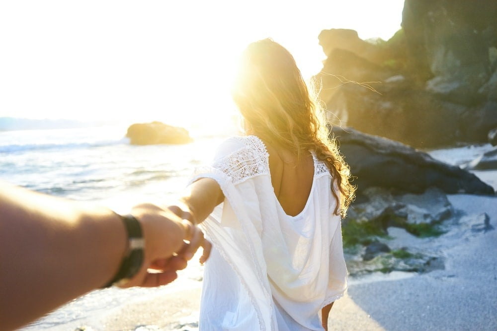 A couple spending time on the beach to focus on improving their relationship.