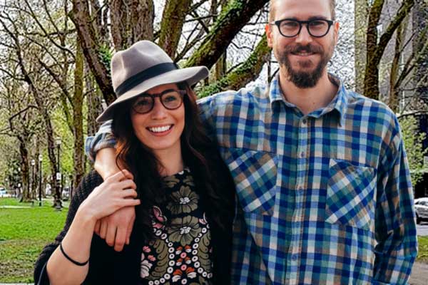 Smiling couple standing together outdoors in Portland park