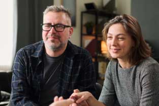 Mature couple holding hands during a marriage counseling session in Silicon Valley